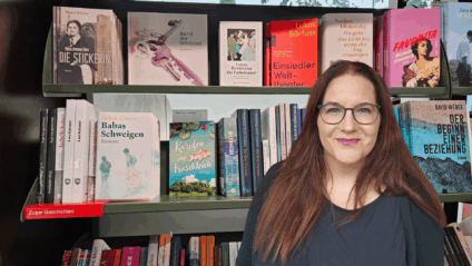 Edith Gould vor einem Bücherregal